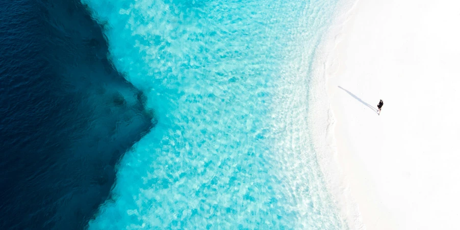 two people on surfboards are in the clear water