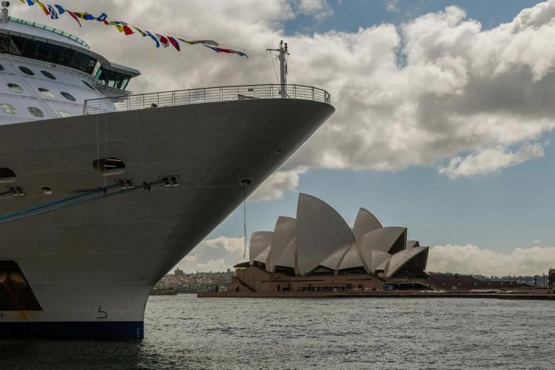 there is a ship in the water next to a large building