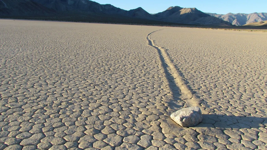 a rock sitting on top of a cement road