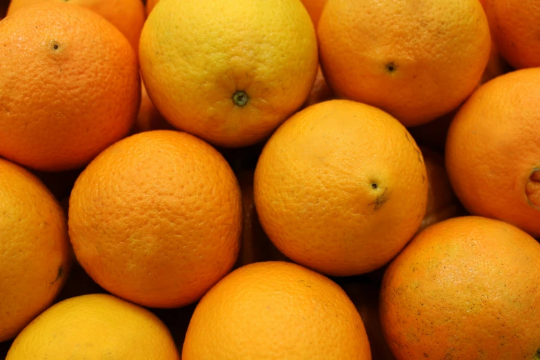 a pile of oranges all stacked together in the middle