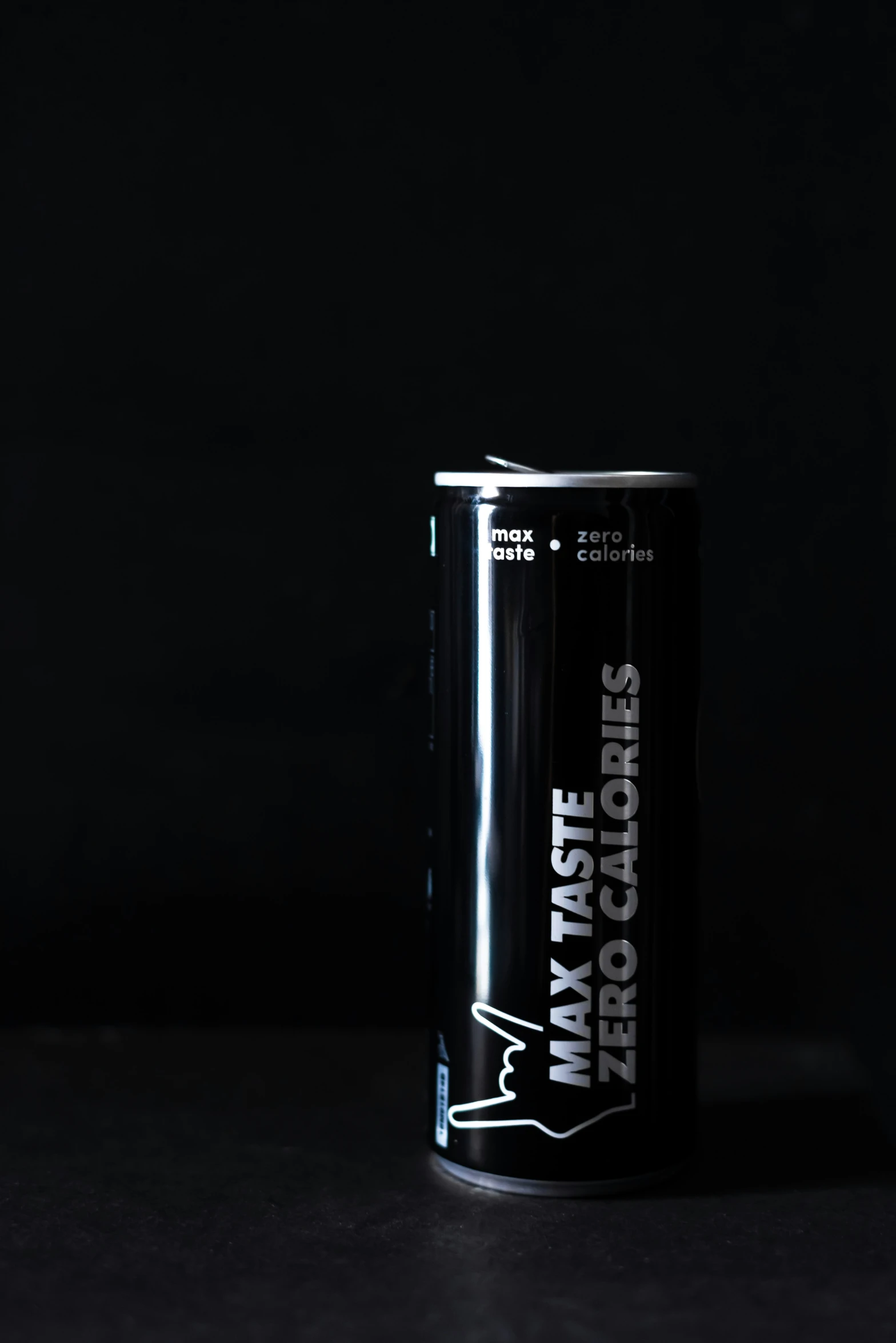 an energy drink on a table with a black background