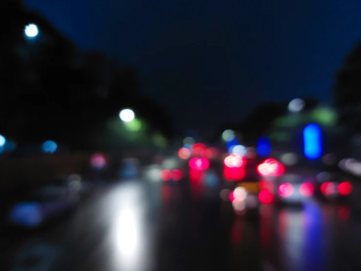 blurry night lights and vehicles on a city street