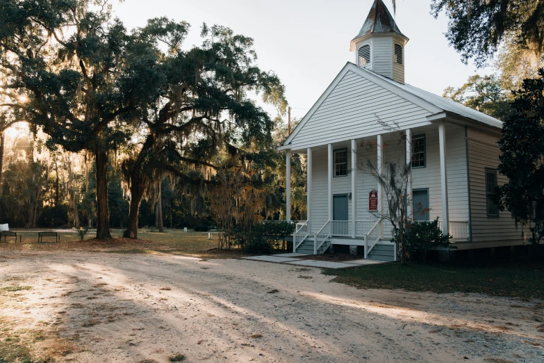 small white church with a steeple in the background