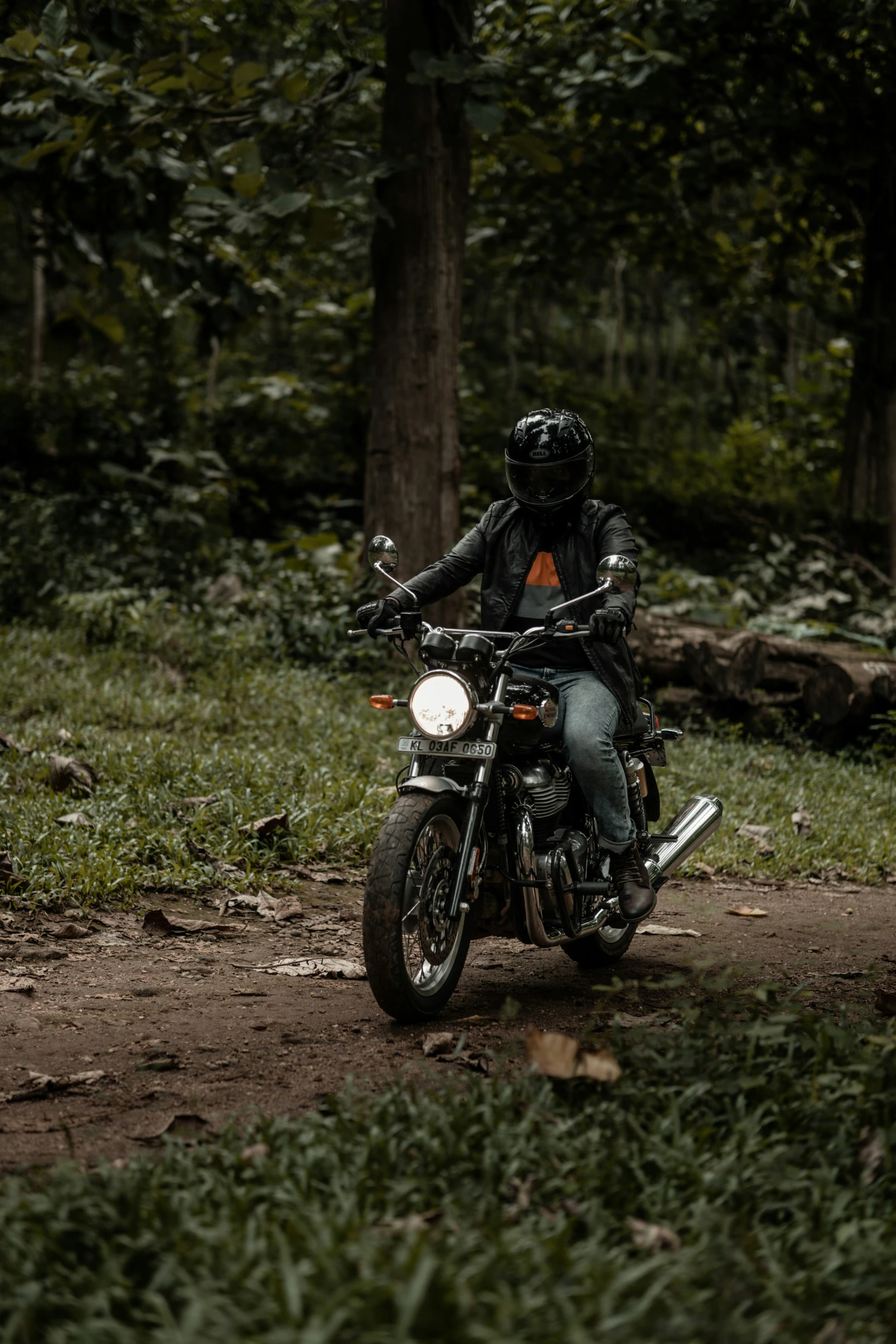 someone riding a motorcycle down a dirt path