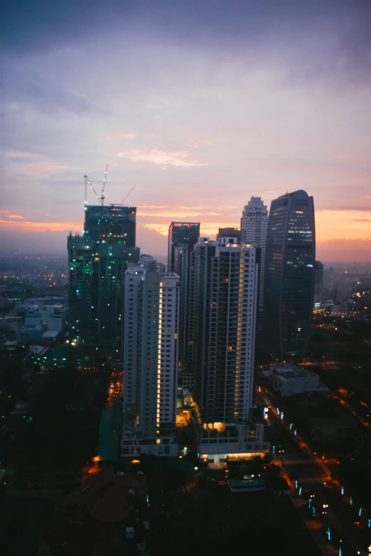 a city skyline with some buildings illuminated up