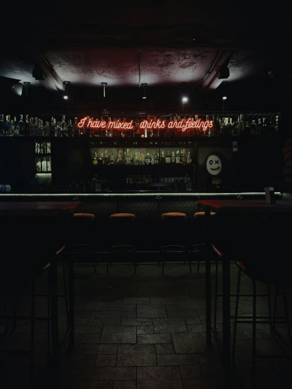 dimly lit bar with empty chairs at night