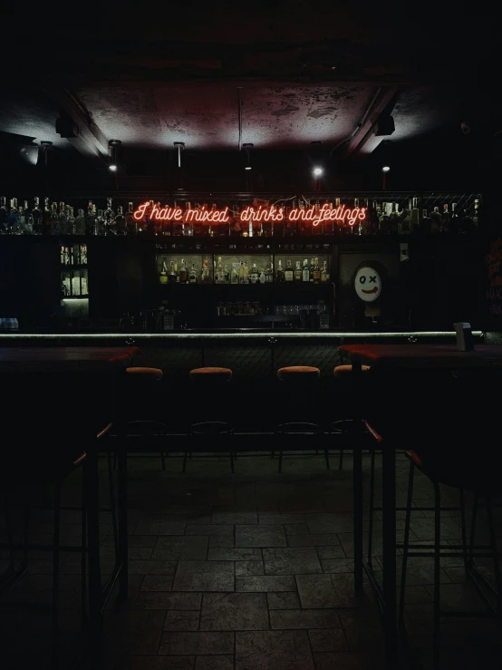 dimly lit bar with empty chairs at night