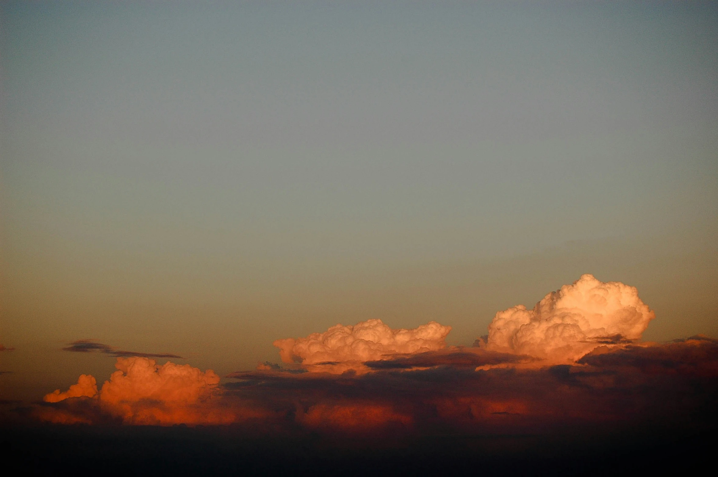 a plane that is flying by some clouds