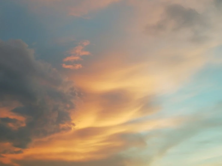 a plane flying in the sky over some clouds