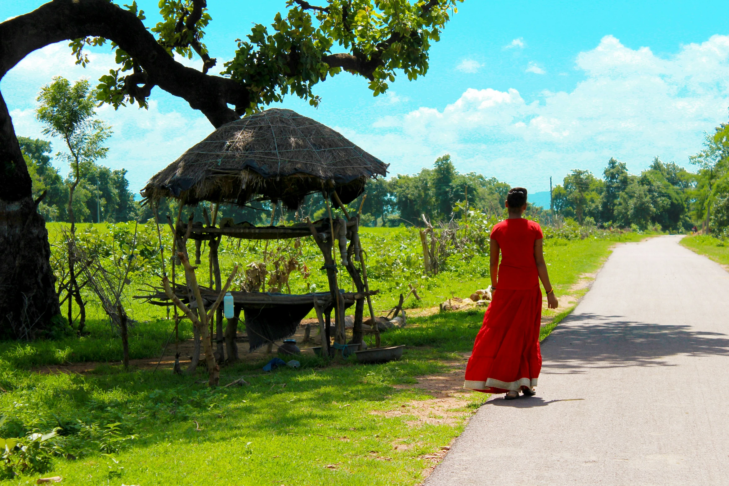 a woman wearing red walking down the street