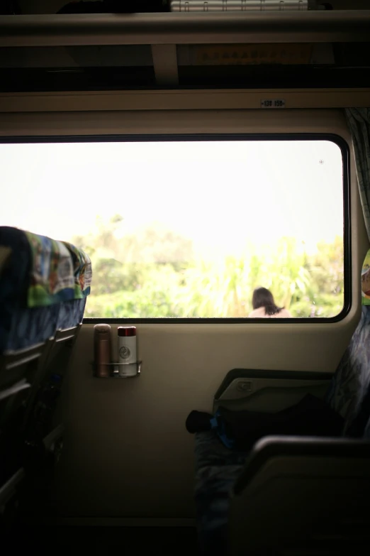 the interior of a bus that is parked next to a grassy area