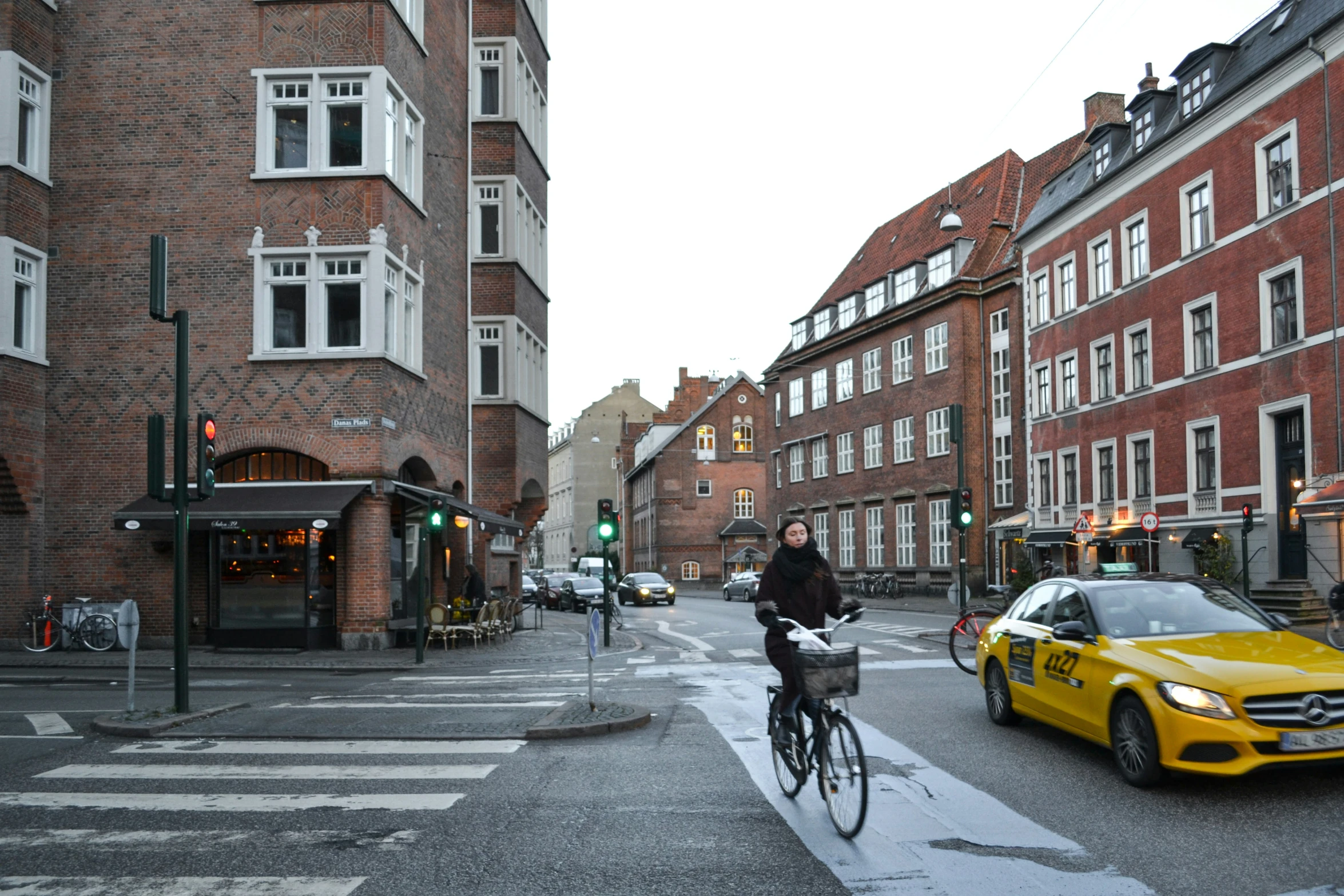 the man is riding his bicycle through a quiet street