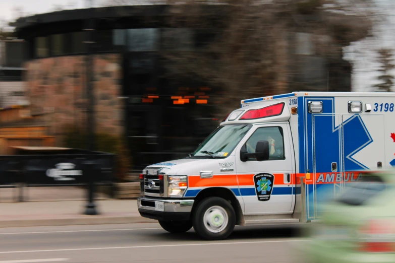 an ambulance moving down the road in a city