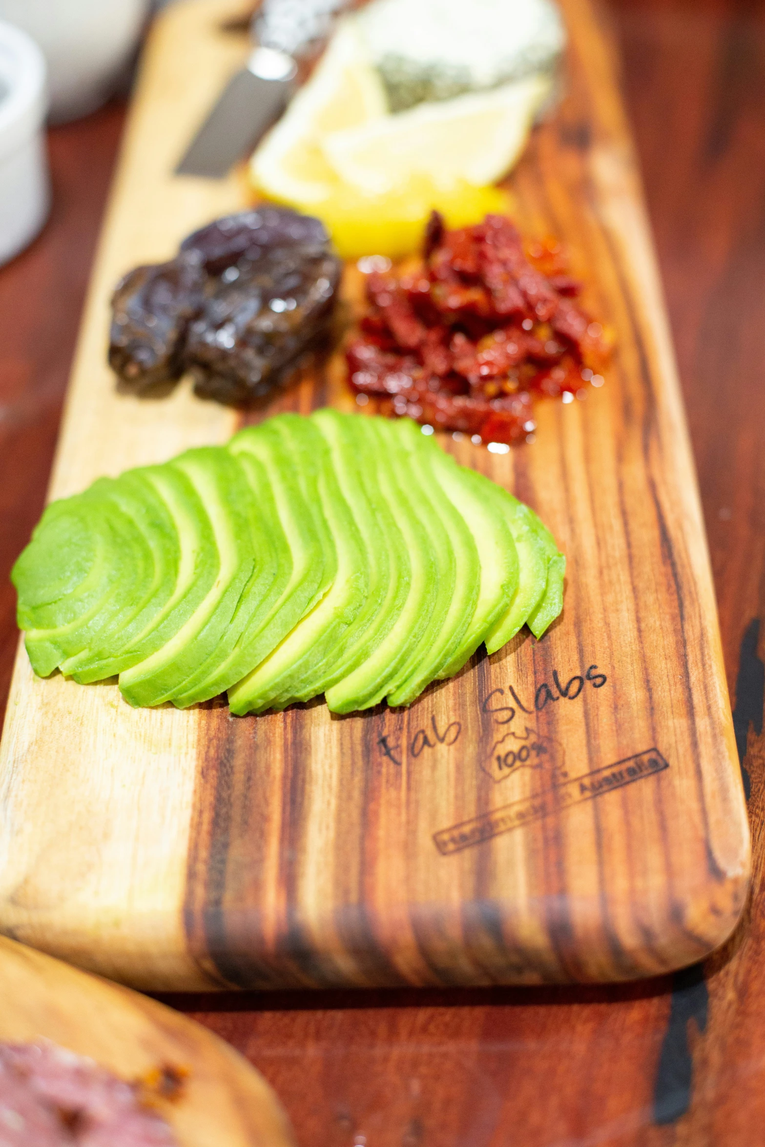 a wooden  board holding sliced green food