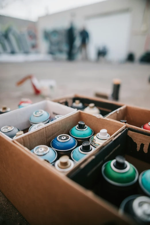 a brown box filled with lots of containers of various colors