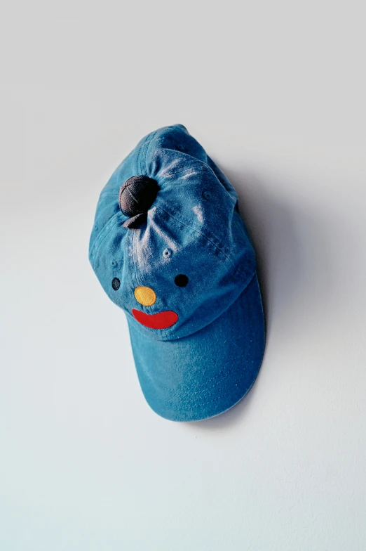 a blue hat is lying on a white table