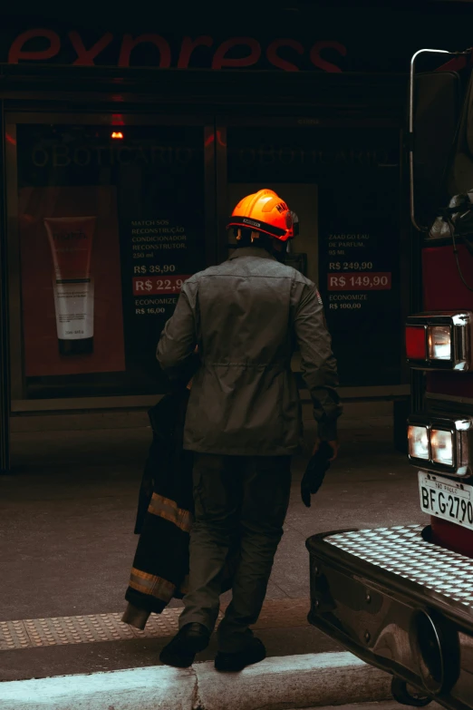 a person with a yellow helmet walks down the street