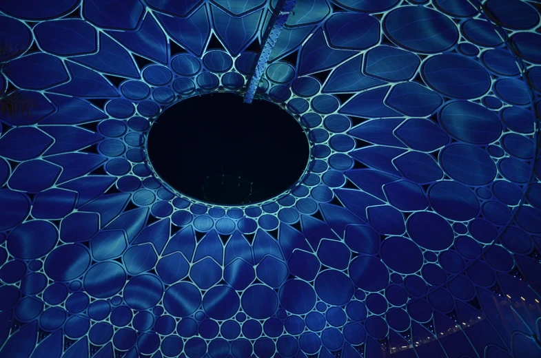the circular hole in the structure is illuminated with many lights