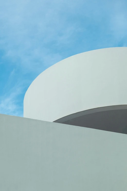 a skateboarder rides along the rim of an outside wall