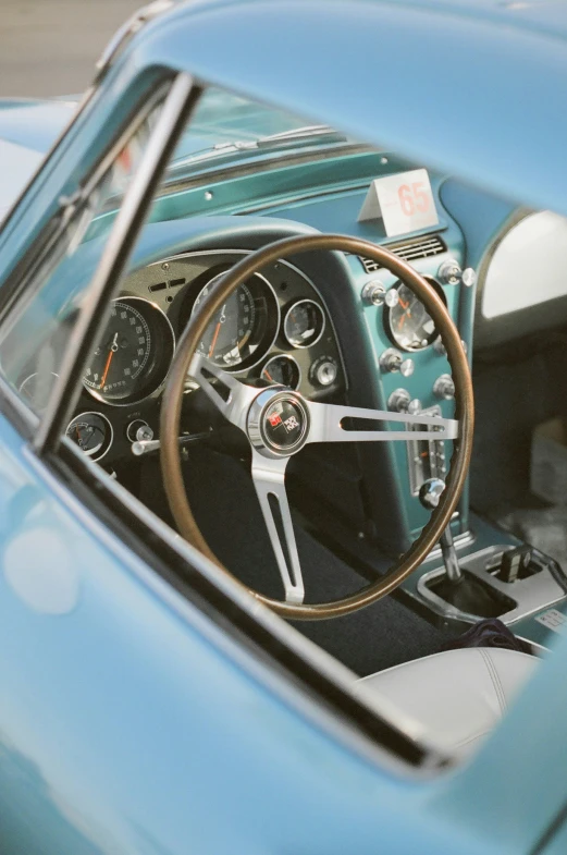 a blue car's dashboard and steering wheel are shown