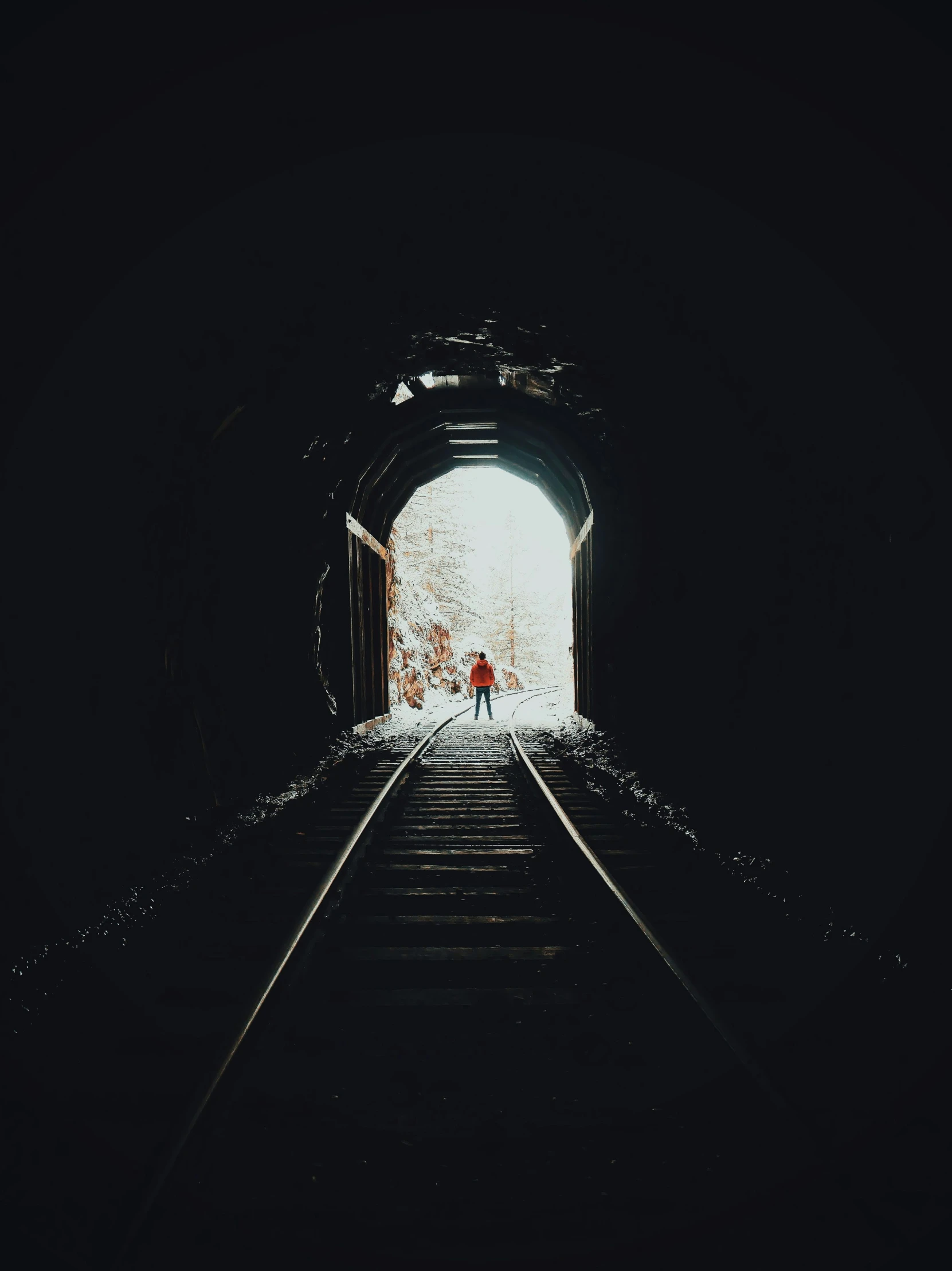 the people in front of the tunnel are on the tracks