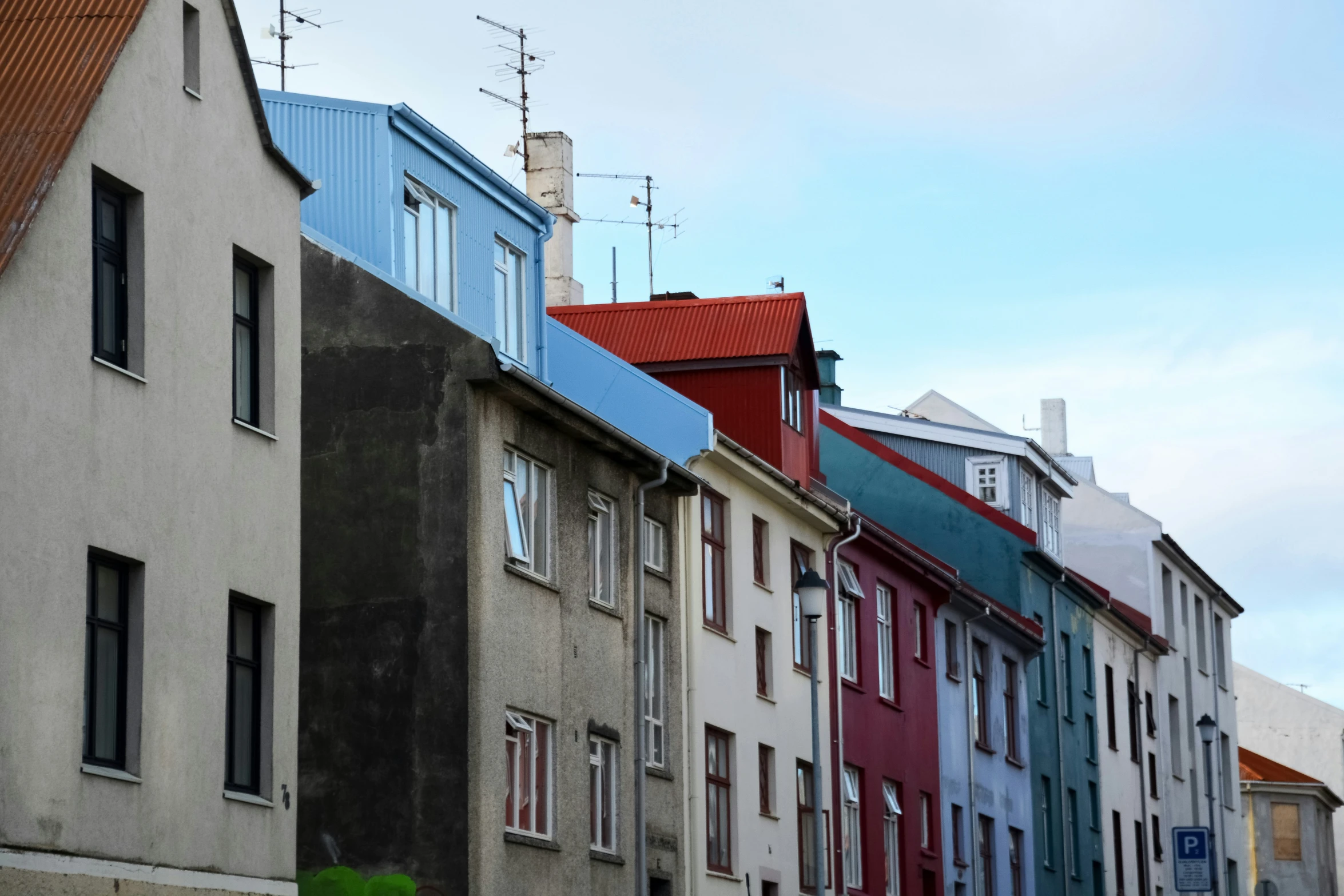 a row of houses line a narrow street