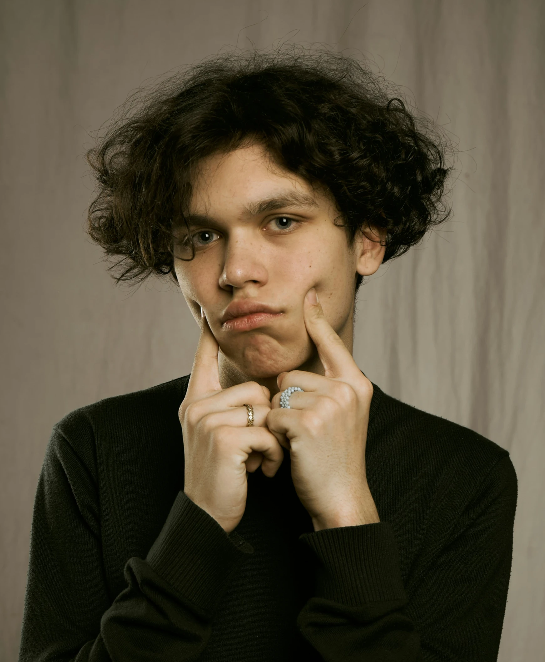 a man poses for the camera wearing a ring