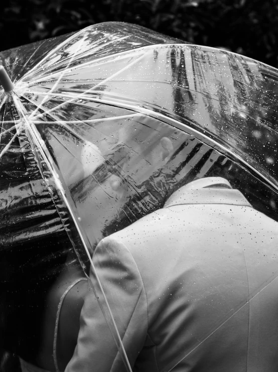 man in a suit and jacket wearing an umbrella