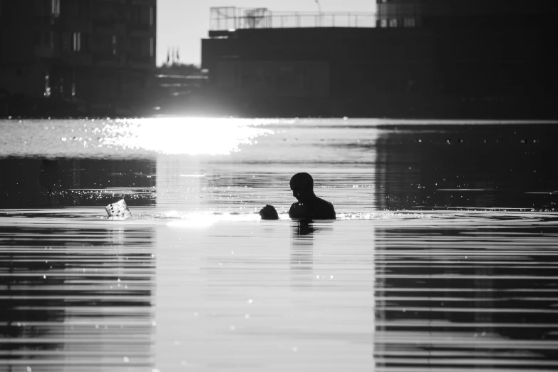 a black and white po of someone swimming in the water