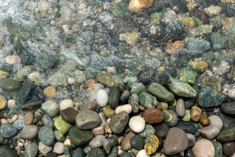some green and yellow rocks and some water