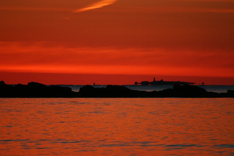 this is an image of a ship sailing in the ocean at sunset