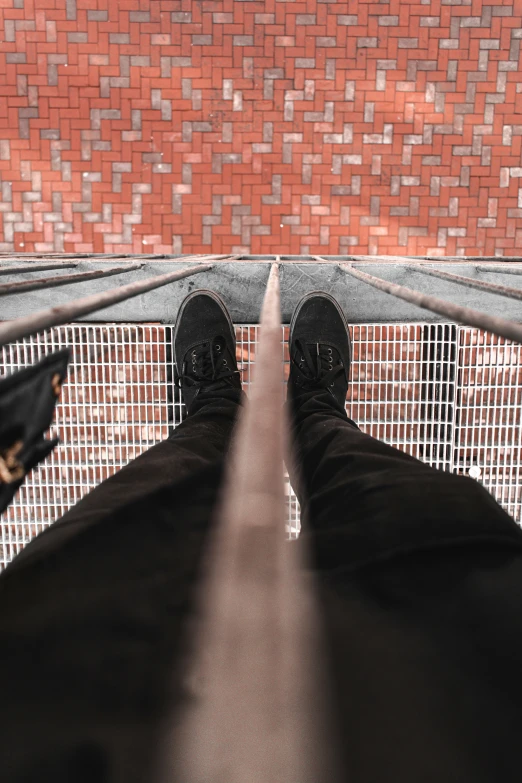 a person standing on top of a metal railing next to a building