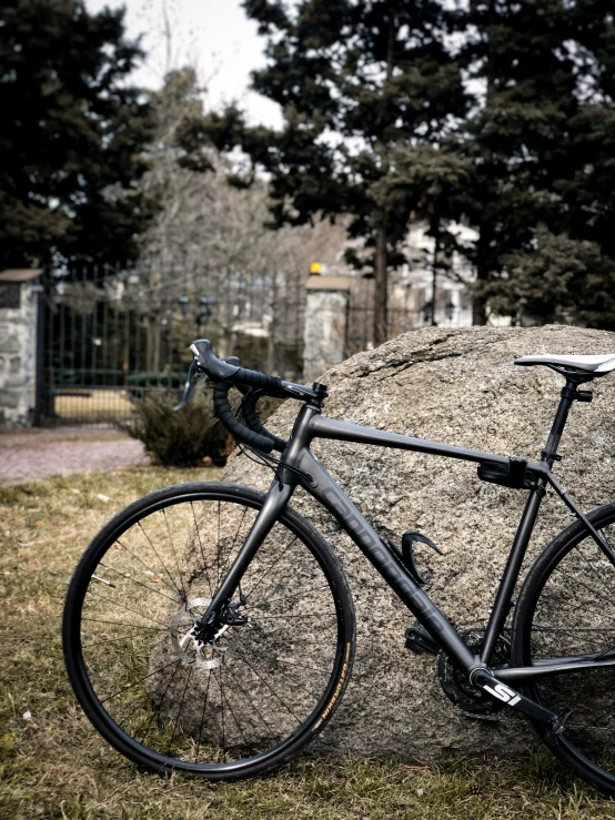 the bike is parked against the hay ball