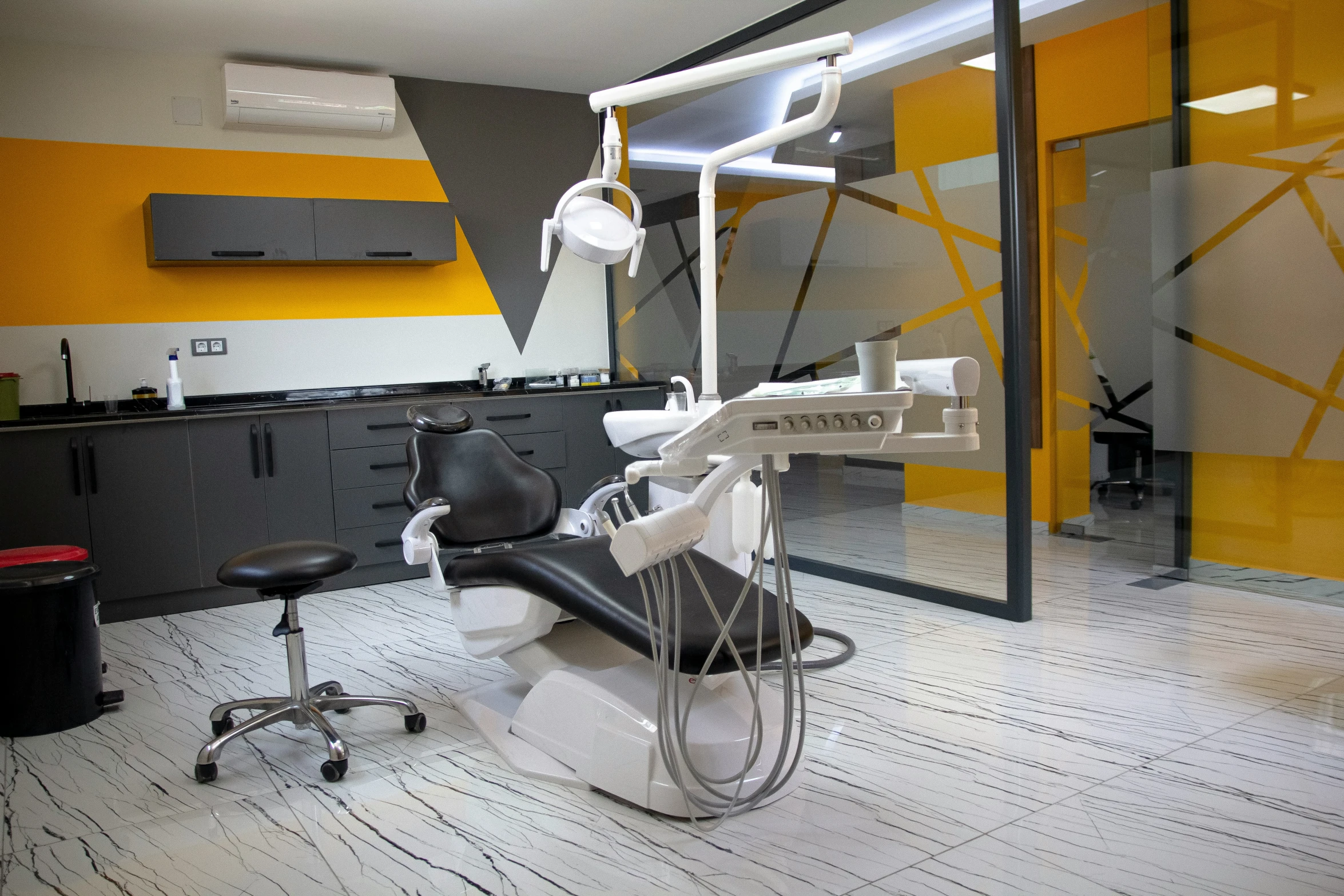 a dentist chair sitting in a room with yellow and white walls