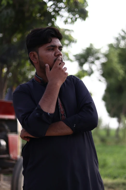 a man looks away while holding his chin up