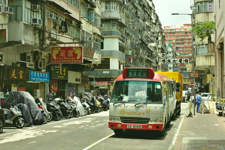 a red and white bus driving through a city