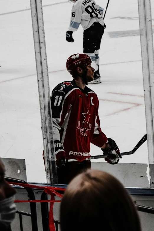 an ice hockey player with a red jersey