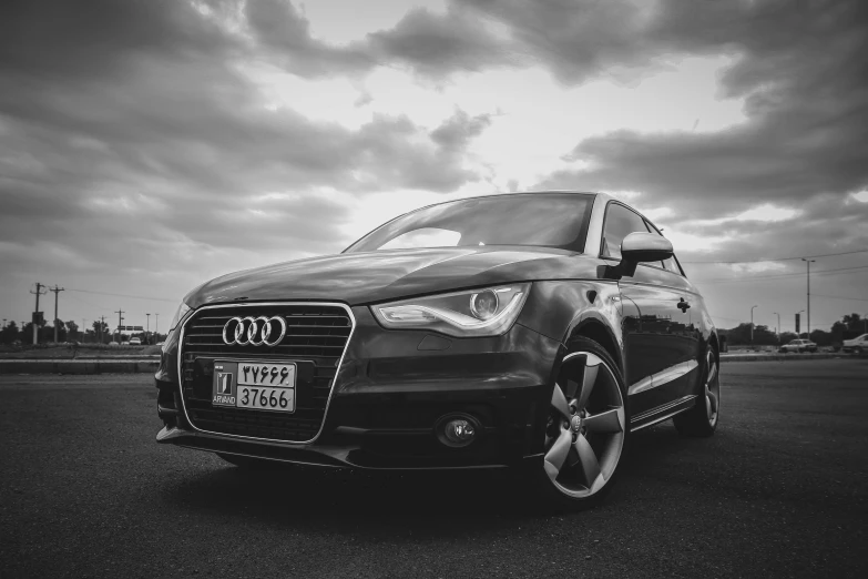 the audi is on a road, near dark clouds