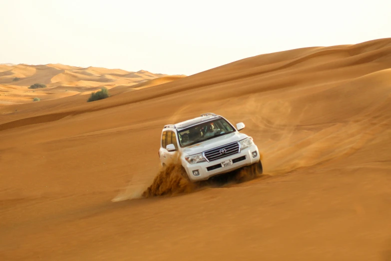 a white van is driving through the desert