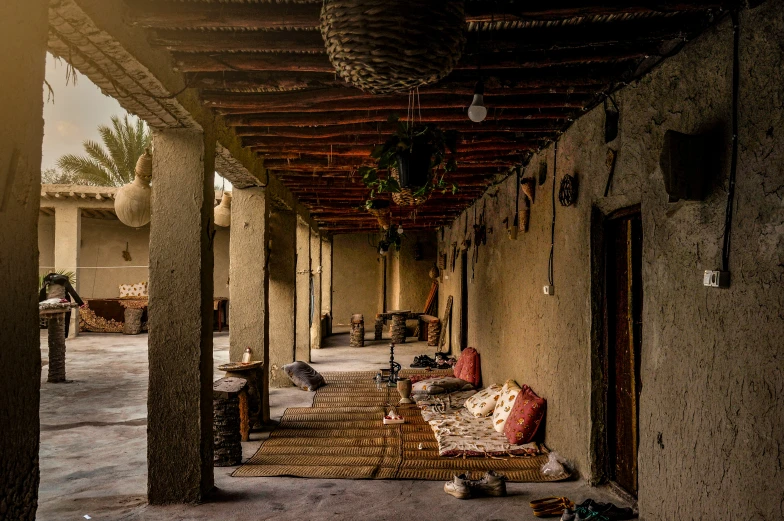 a covered porch that has seating under an umbrella