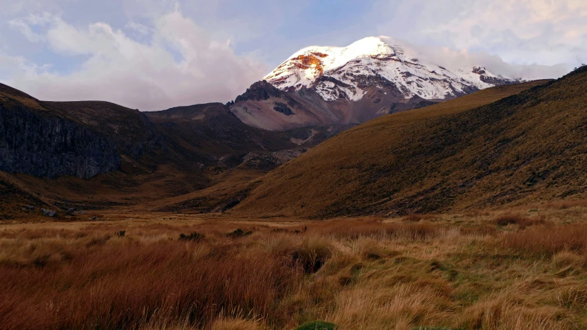 a large mountain with snow covered peaks