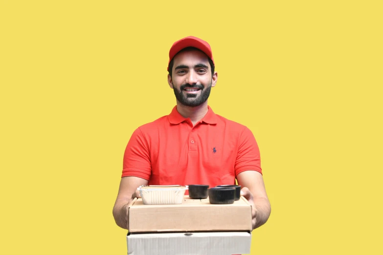 a man holding a pizza box in his hands