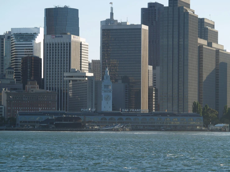 a view of a body of water in front of many buildings