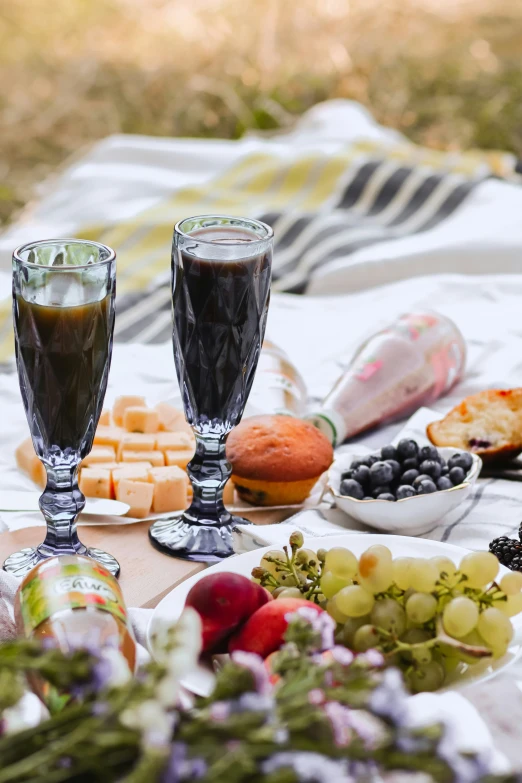 a table topped with desserts next to a cup of coffee