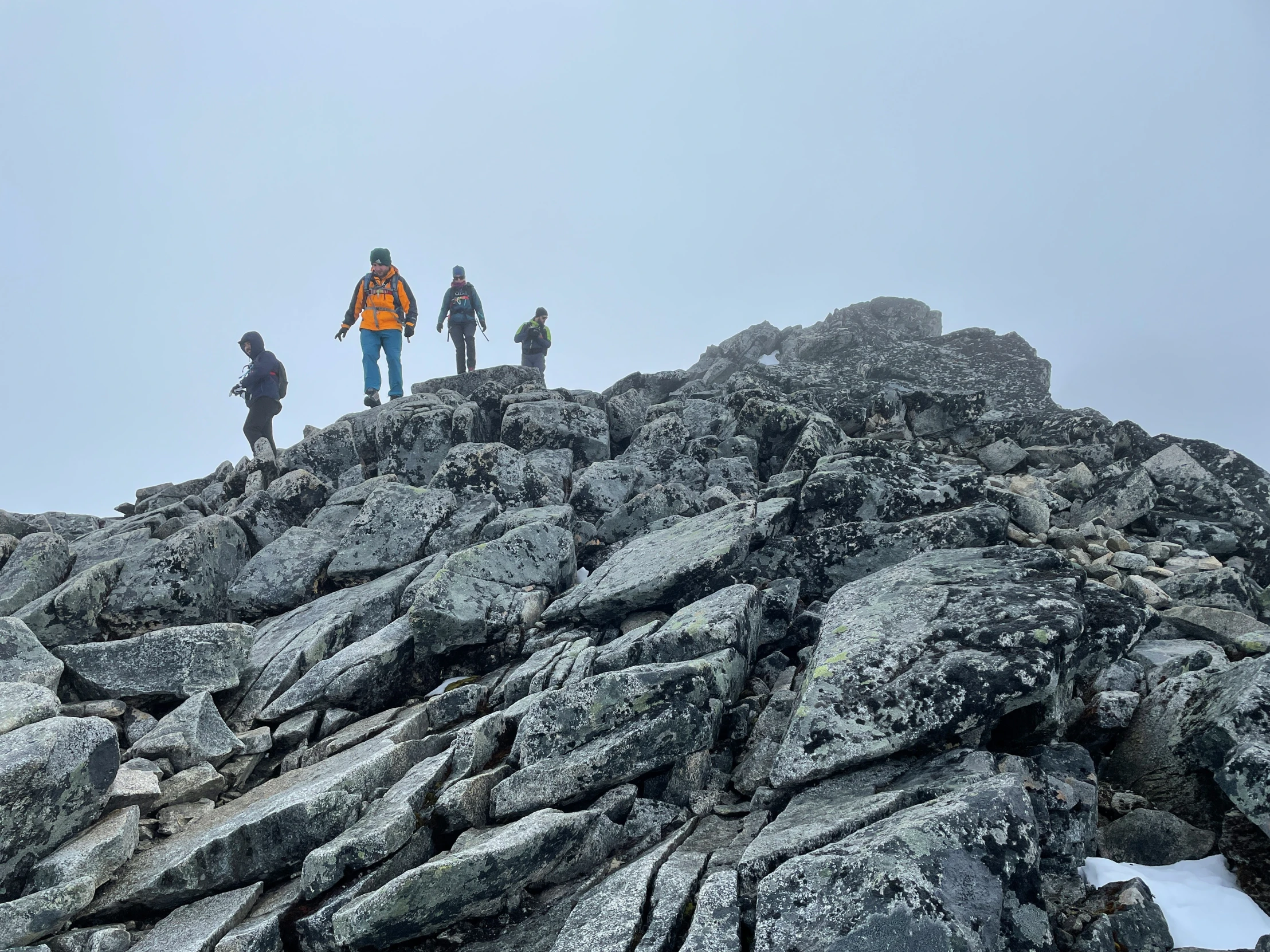 people standing on a mountain side while hiking