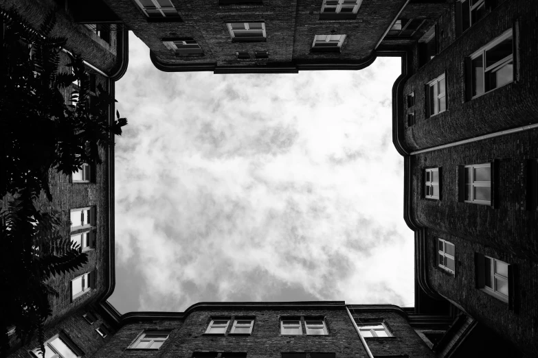 black and white looking up at an apartment building