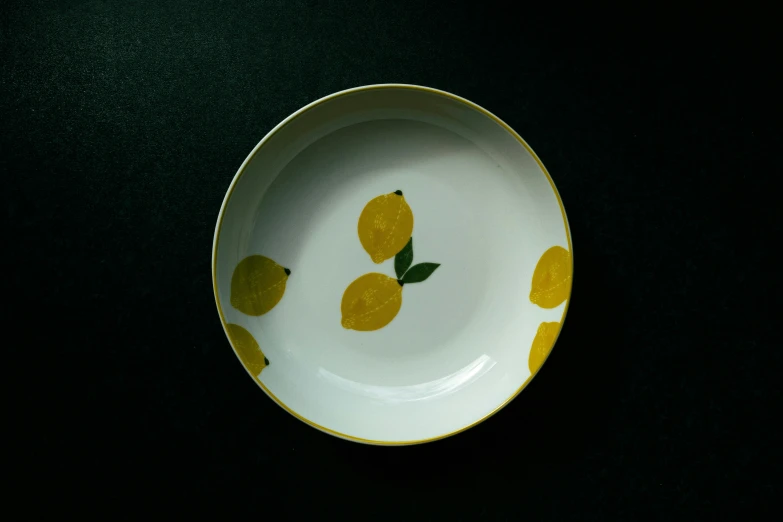an empty yellow bowl sitting on top of a table
