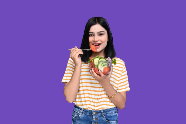 the woman has been taking a cut - out picture of herself eating an apple