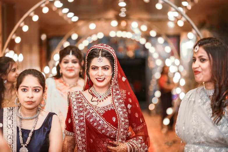 a bride smiles at the camera as other bridals stand by