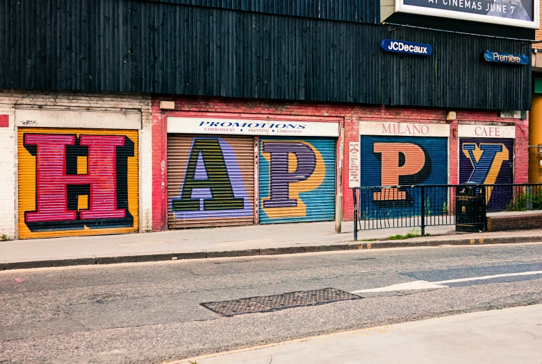 large colorful storefronts are covered by graffiti